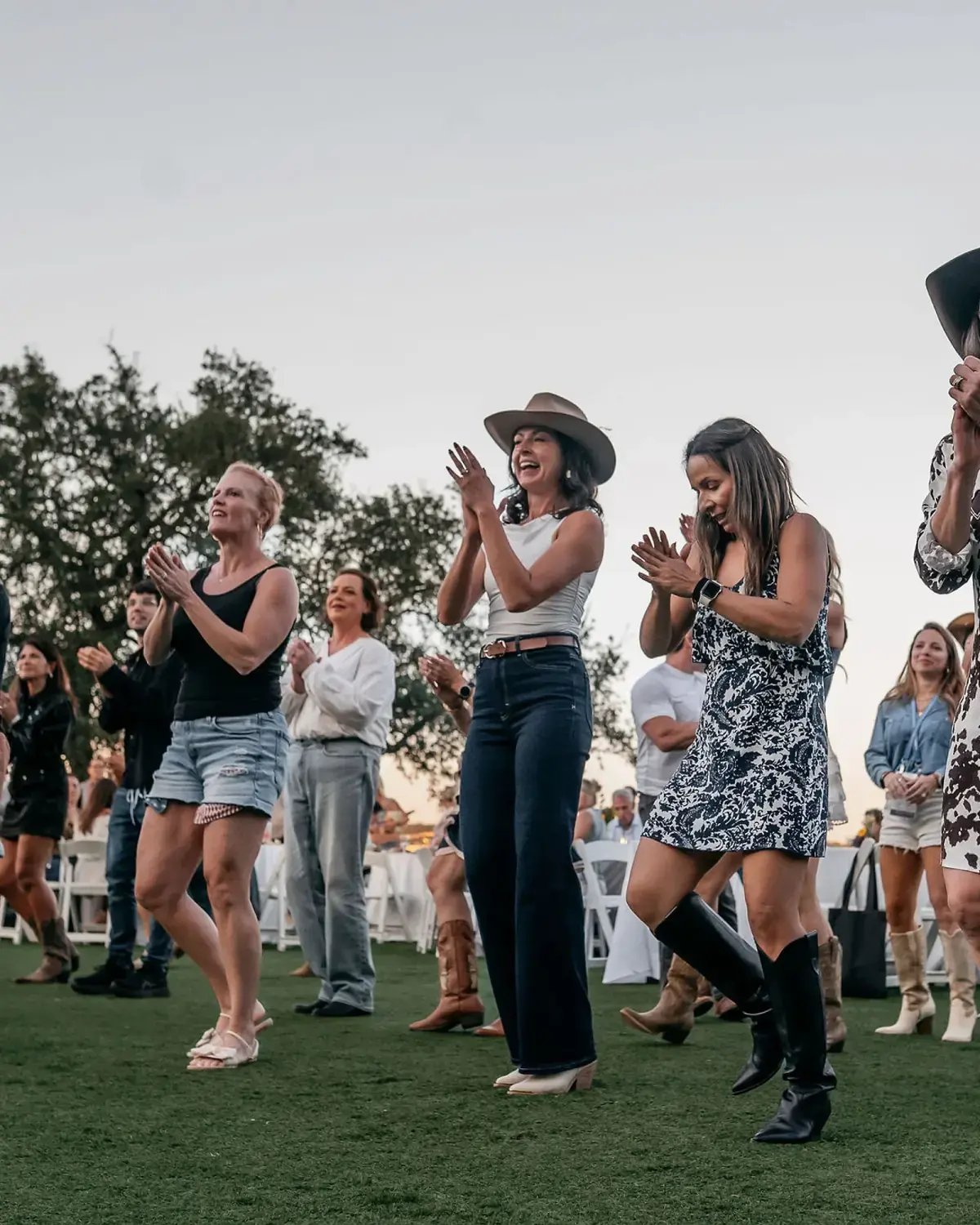 Conference attendees taking part in an outdoor line-dancing experience