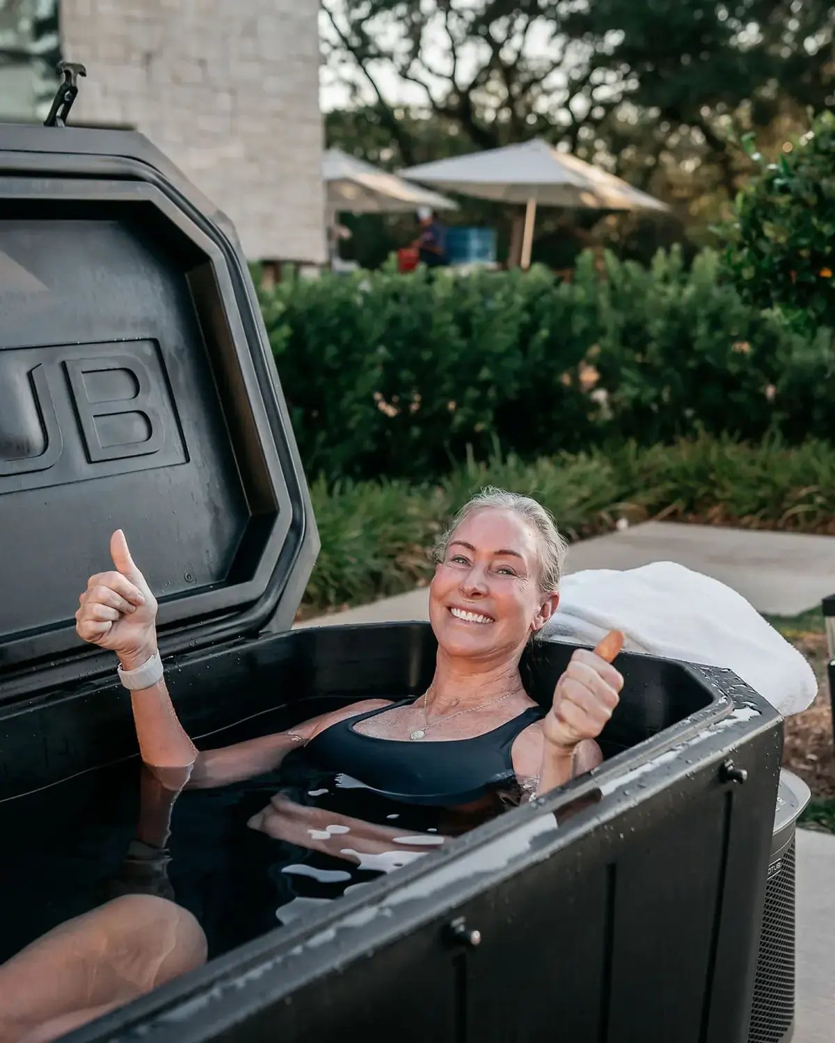 Conference attendee smiling during an outdoor cold-plunge activation