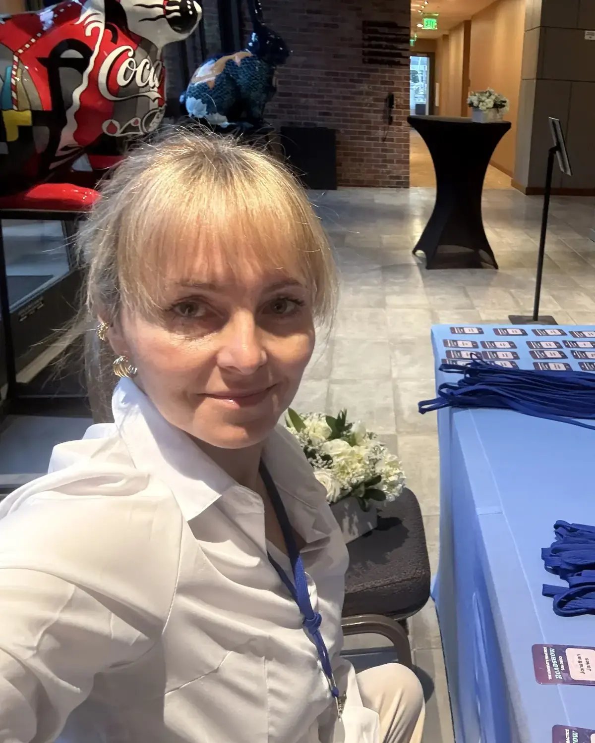 PSG Events founder Magdalena Bonnelly preparing badges and registration materials at an event check-in desk